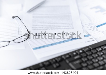 picture of signed contract paper with glasses