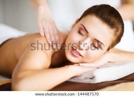 beauty and spa concept - woman in spa salon getting massage
