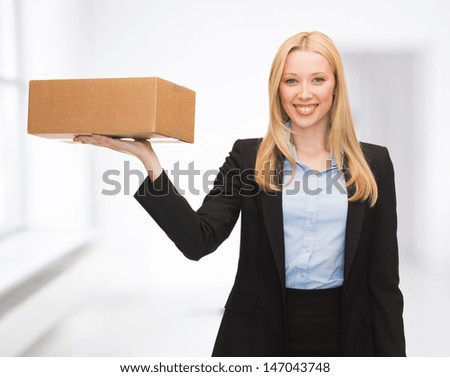 attractive young businesswoman delivering cardboard box indoor