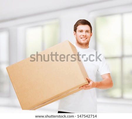 new home and post delivery concept - smiling man carrying carton box