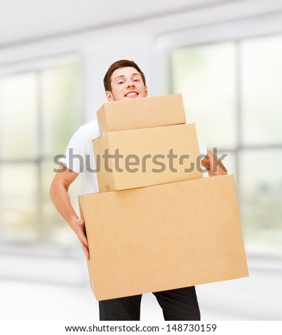 home, postal service and delivery - young man carrying carton boxes