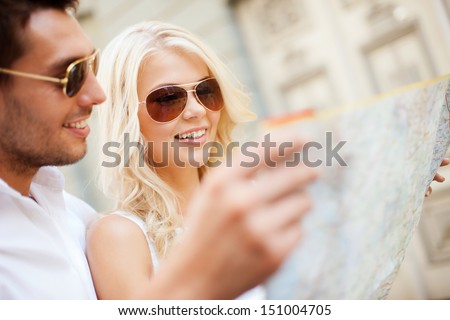 summer holidays, dating and tourism concept - couple with map in the city