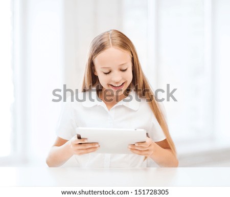 education, school, technology and internet concept - student girl with tablet pc at school