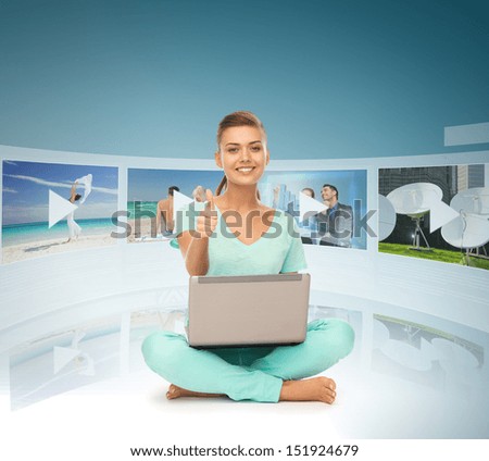 technology, internet, tv and news concept - young woman with laptop pc and virtual screens