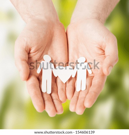 eco, bio, nature, love, harmony concept - man hands showing two paper men with heart shape