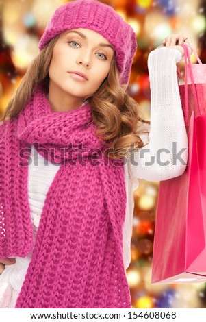 holidays, sale, christmas concept - beautiful woman in winter clothes with shopping bags