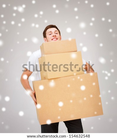 delivery, post, package concept - young man carrying carton boxes