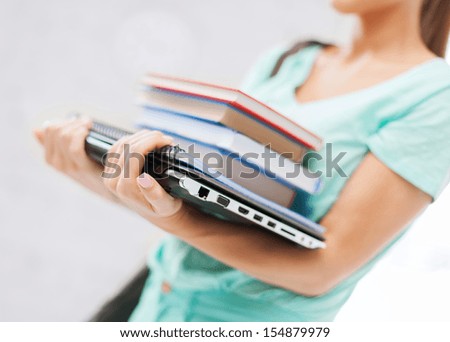 business, office, school and education concept - student with books, computer and folders