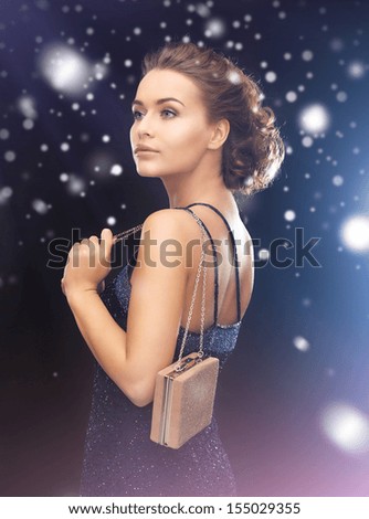 luxury, vip, nightlife, party concept - beautiful woman in evening dress with small bag