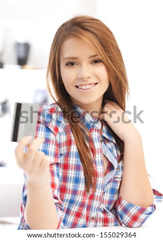 banking and shopping concept - happy teenage girl with credit card