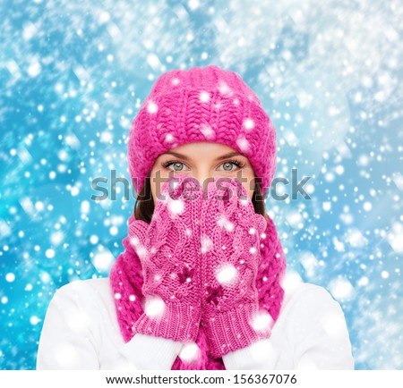 christmas, x-mas, winter, happiness concept - surprised woman in hat, muffler and mittens