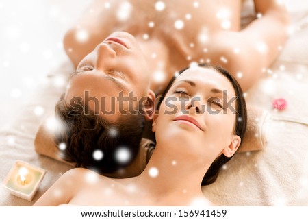 health and beauty concept - couple in spa salon lying on the massage desks