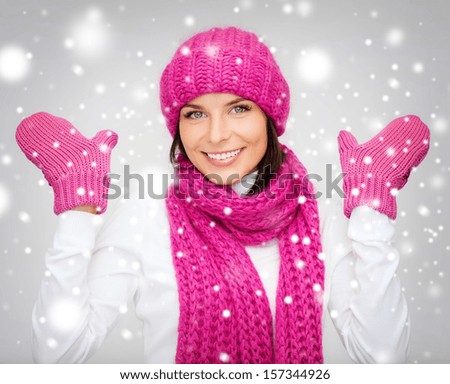 winter, people, happiness concept - woman in hat, muffler and mittens