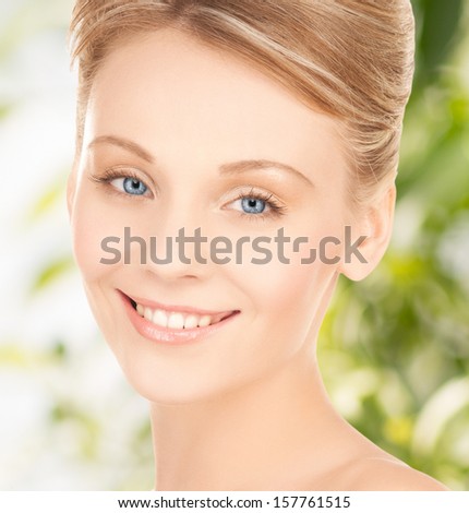 health and beauty, eco, bio, nature concept - face of beautiful woman with updo hair