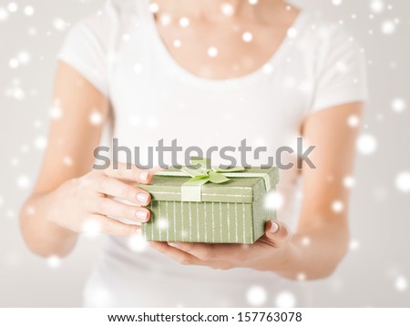 christmas, x-mas, gifts, presents, celebration concept - woman hands holding gift box