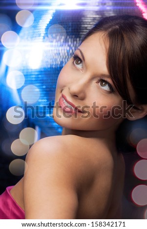 luxury, vip, nightlife, party, clubbing concept - beautiful woman in evening dress with disco ball