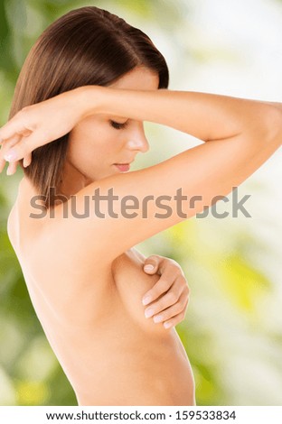 health and beauty, eco, bio, nature concept - woman checking breast for signs of cancer