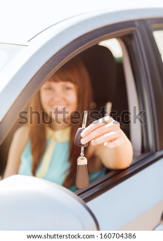 vehicle, rental, automotive concept - happy woman holding car key