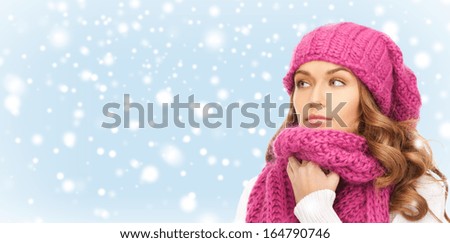 winter, people and happiness concept - beautiful woman in pink winter hat and muffler