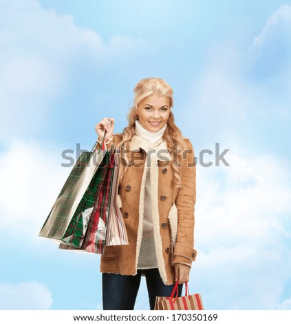 sale and shopping concept - lovely woman with shopping bags