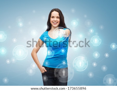 communication, future technology and people concept - happy girl in blue t-shirt pointing at social network