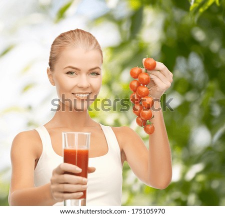 gitness and diet concept - young woman holding glass of juice and tomatoes