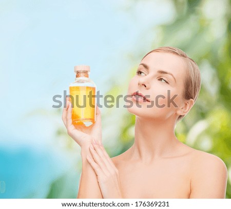 health, spa and beauty concept - lovely woman with oil bottle