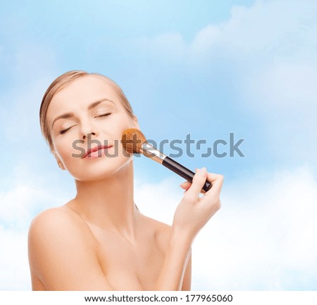 cosmetics, health and beauty concept - beautiful woman with closed eyes and makeup brush