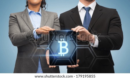 business, technology and internet concept - businessman and businesswoman with bit coin sign on tablet pc screen