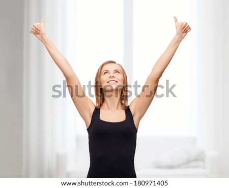 t-shirt design, happy people concept - smiling woman in blank black tank top showing thumbs up