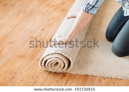 A carpet being installed of top of wooden flooring