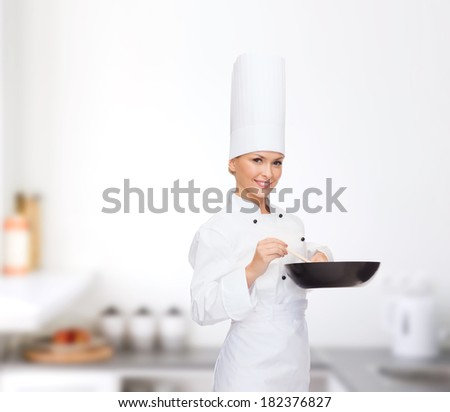 cooking and food concept - smiling female chef with pan and spoon