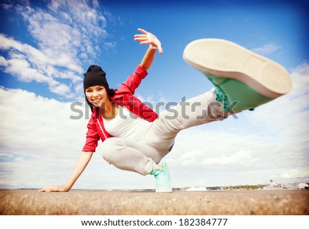 sport, dancing and urban culture concept - beautiful dancing girl in movement