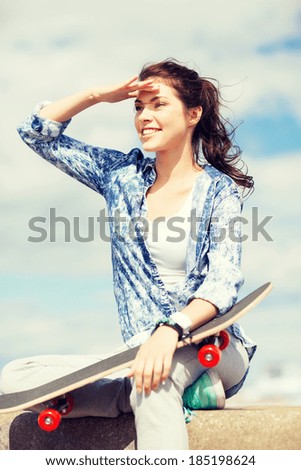 summer holidays and teenage concept - teenage girl with skate outside