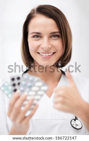 healthcare and medical concept - doctor with blister packs of pills