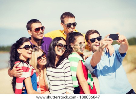 summer, holidays, vacation, happy people concept - group of friends taking selfie with smartphone