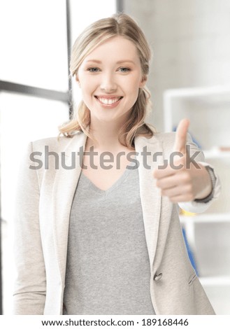 business concept - young woman with thumbs up