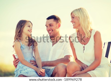 summer holidays, children and people concept - happy family having a picnic