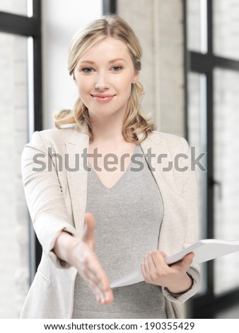 business concept - lovely woman with an open hand ready for handshake