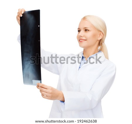 healthcare, medicine and radiology concept - smiling female doctor looking at x-ray