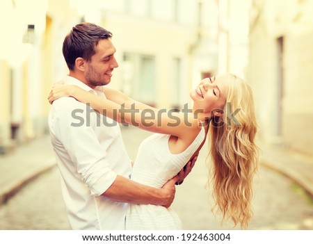 summer holidays, love, relationship and dating concept - smiling couple dancing in the city