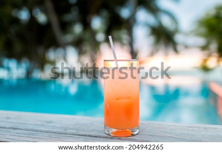 summer, beach, drink, cocktail and leisure concept - cocktail drink on tropical beach
