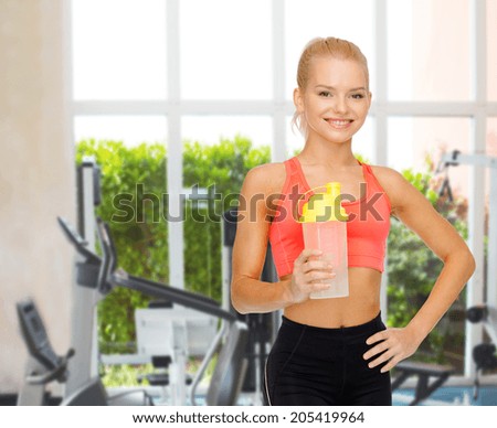 sport, fitness and diet concept - smiling sporty woman with protein shake bottle