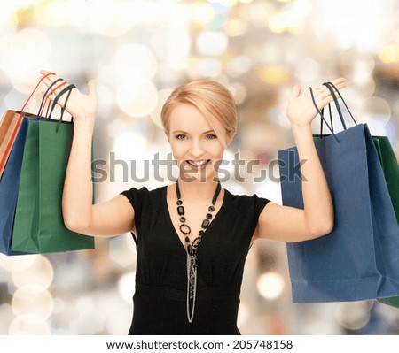 shopping and retail concept - lovely woman with shopping bags