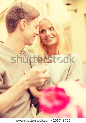 summer holidays, love, travel, tourism, relationship and dating concept - romantic happy couple in the cafe
