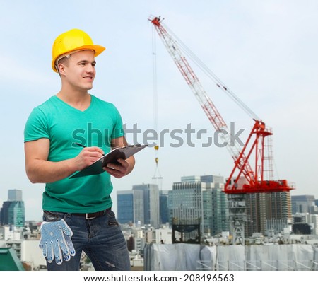 repair, building, construction and maintenance concept - smiling man in helmet with clipboard making notes