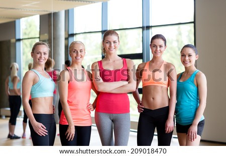 fitness, sport, friendship and lifestyle concept - group of women in gym