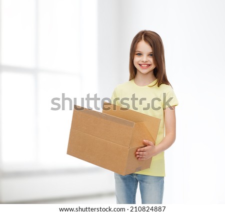 advertising, childhood, delivery, mail and people - smiling little girl holding open cardboard box over white room background