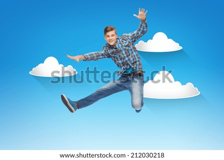 happiness, freedom, movement and people concept - smiling young man jumping in air over blue sky with white clouds background