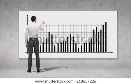 business, development and office people concept - businessman with marker drawing chart over concrete wall background from back